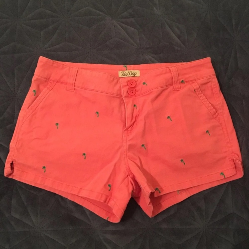 Coral shorts with green palm tree details